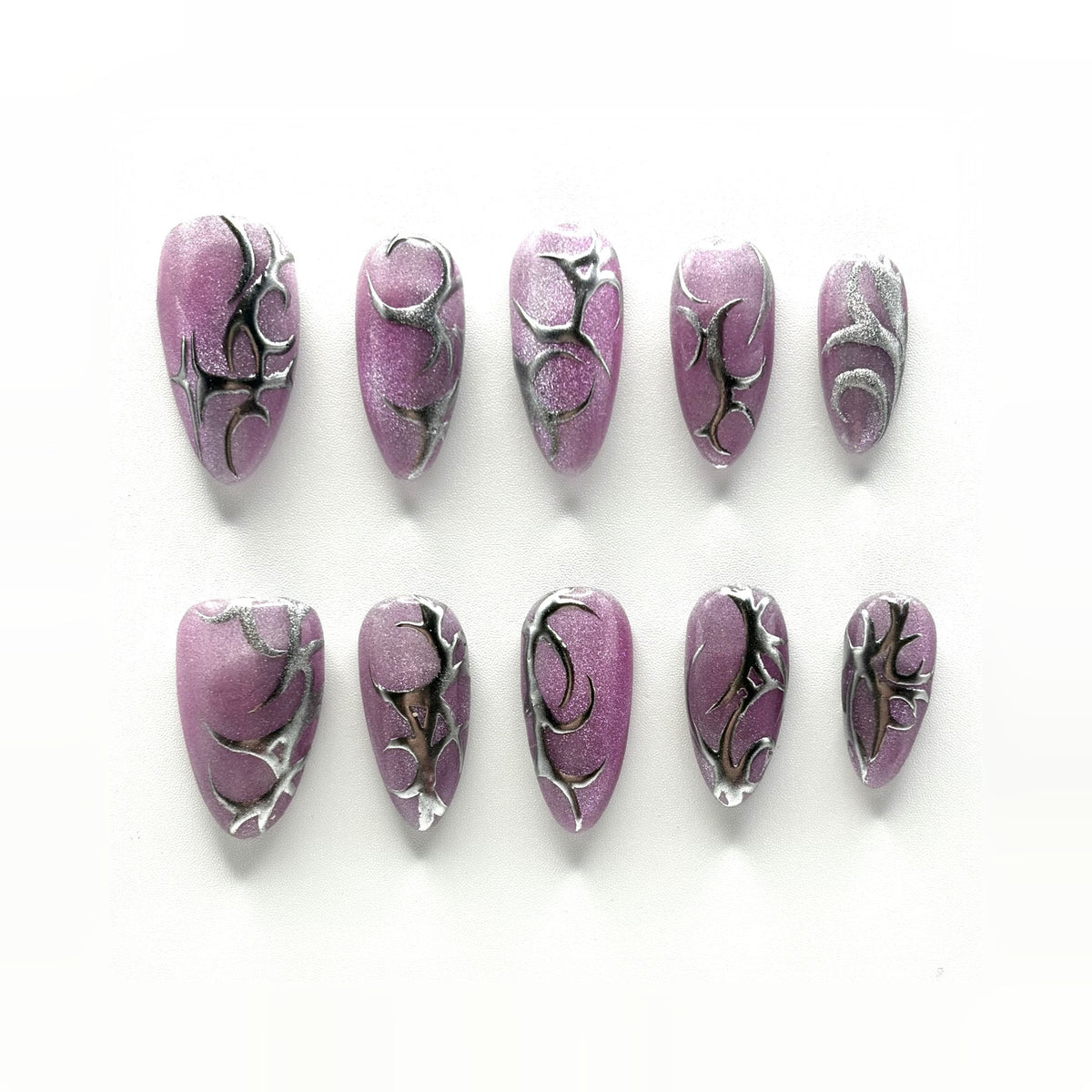 Chrome Thorn press-on nails: mulberry cat-eye chrome almonds with hand-drawn silver thorns, different on every nail
