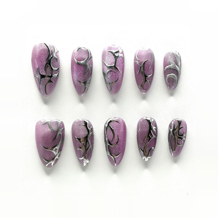 Chrome Thorn press-on nails: mulberry cat-eye chrome almonds with hand-drawn silver thorns, different on every nail