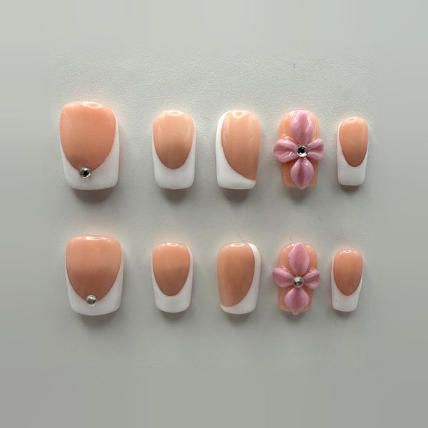 Pink Sugar French press-on nails: short square rosy nude French tips, plus two nails with sculpted pink flowers