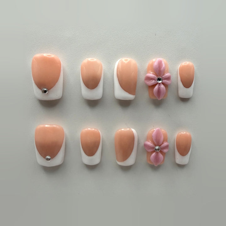 Pink Sugar French press-on nails: short square rosy nude French tips, plus two nails with sculpted pink flowers