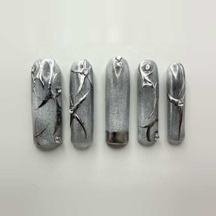 Cyberqueen press-on nails: ten long square silver cat-eye nails with raised mirror-chrome vines and clear rhinestones