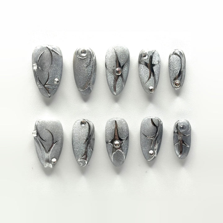 Liquid Silver press-on nails: holographic silver almonds with raised mirror line work, four-point stars and clear crystals