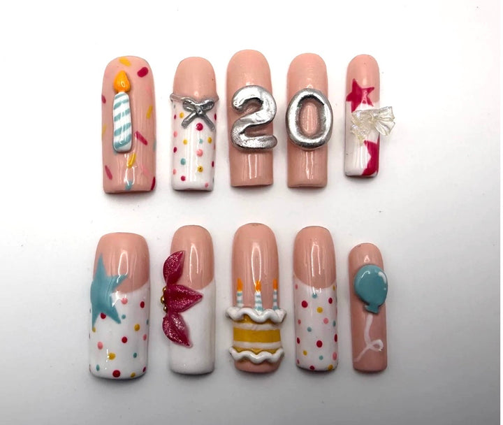 Confetti Birthday press-on nails: long square nudes with sprinkles, a sculpted cake, candle, balloon and a silver 20
